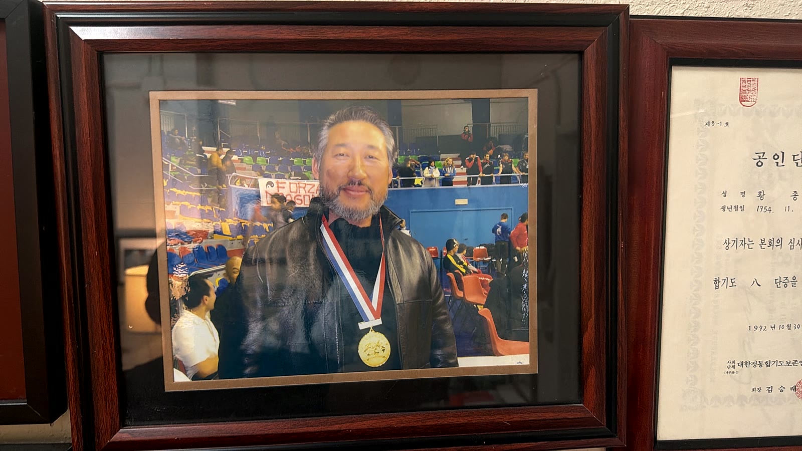 Grand Master Hwang wearing a championship gold medal